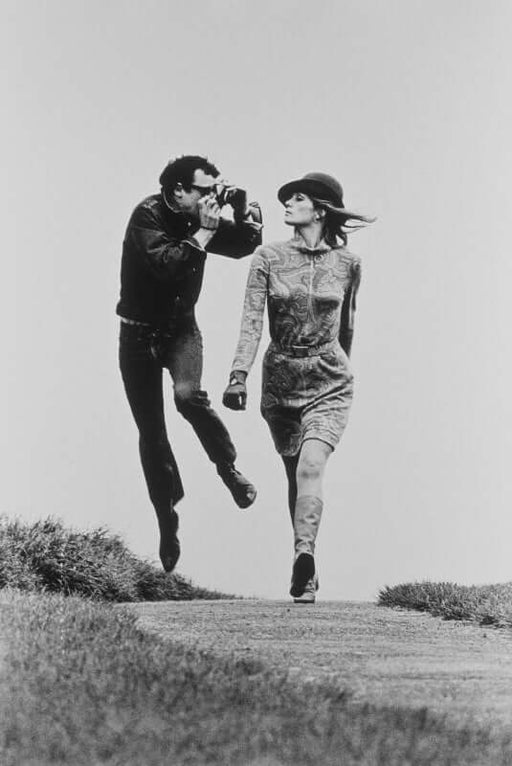Helmut Newton Action Shot France 1975 vintage silver gelatin print, photographer jumping beside model walking on path, 16x20 print