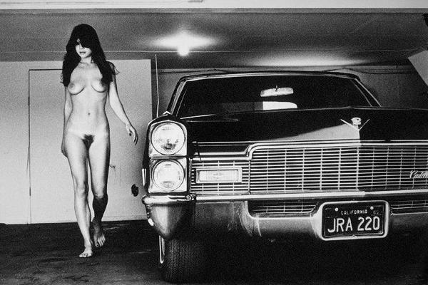 Alt Tag: Helmut Newton Hollywood Cadillac 1976 vintage silver gelatin print nude woman walking beside Cadillac in garage, black-and-white photo
