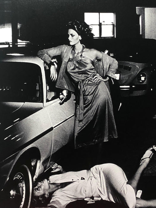 Alt Tag: Helmut Newton Models Inspecting Brake Lining vintage silver gelatin print Paris 1977 models posed by car in garage