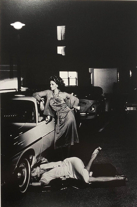 Helmut Newton Models Inspecting Brake Lining vintage silver gelatin print Paris 1977 models by car, cinematic black-and-white photo