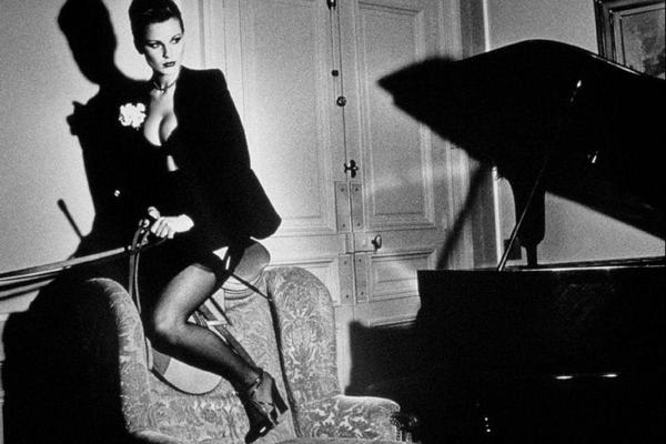 Alt Tag: Helmut Newton Saddle II Paris 1976 vintage silver gelatin print fashion photograph of model posed on sofa beside piano