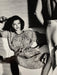 Alt Tag: Helmut Newton Woman Examining Man vintage silver gelatin print Vogue Saint-Tropez 1975 woman reclining as man stands nearby